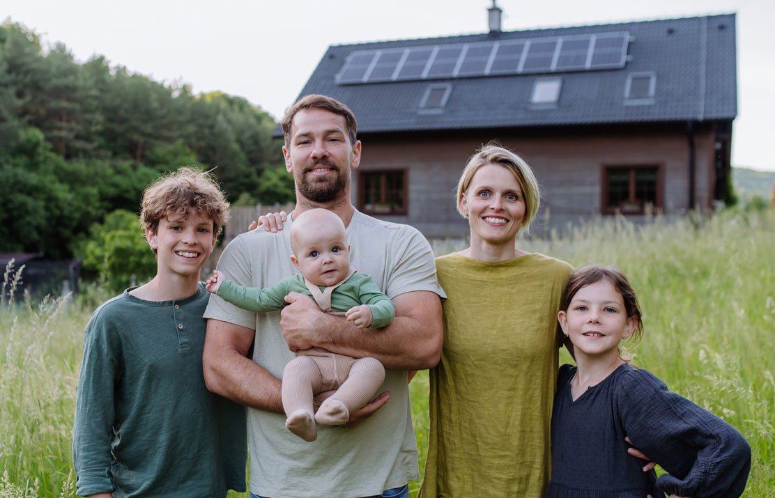 happy family near house with solar
